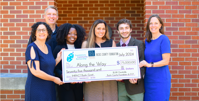 Members of the Along the Way team accept the $75,000 IMPACT Bucks Grant from a coalition of local funders